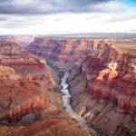 Tourist Slashed On Famed Trail Grand Canyon with river winding through layered red cliffs