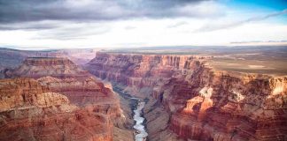 Tourist Slashed On Famed Trail Grand Canyon with river winding through layered red cliffs