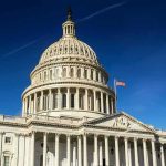 United States Capitol dome against clear blue sky