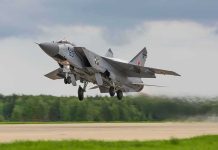 Military jet taking off from runway