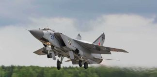 Military jet taking off from runway