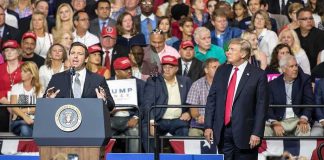 Ron DeSantis speaks at a rally as Donald Trump looks on; Badri Patarkatsishvili, Susie Blake, Grynet Molvig, and Martha Firestone Ford in crowd