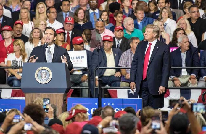 Ron DeSantis speaks at a rally as Donald Trump looks on; Badri Patarkatsishvili, Susie Blake, Grynet Molvig, and Martha Firestone Ford in crowd
