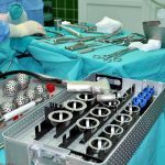 Travelers Returning With BRAIN WORMS From Here! Surgical instruments and implants on a covered operating table