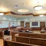 Outrage Erupts: Starved Baby, No Prison Empty courtroom with wooden benches and judge's bench