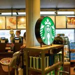 Islamic Foot Baths Coming to U.S Airports Starbucks counter with illuminated logo and customers