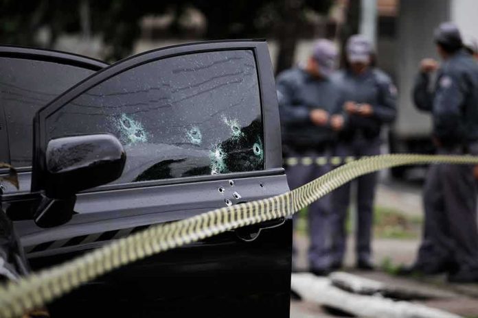 Car door with bullet holes at a taped-off crime scene