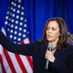 Kamala Says the Quiet Part Out Loud as She Whines About Republican Efforts Kamala Harris speaking with microphone and gesturing on stage