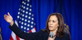 Kamala Harris speaking with microphone and gesturing on stage