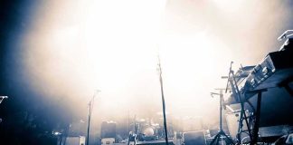 Empty concert stage with instruments and bright lights