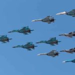 Air Force To Build First CCA Drones! A formation of military jet fighters flying in a clear blue sky
