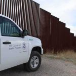 Illegals Find Out It’s a BAD Idea to Try to Enter Country on Jet Skis Border patrol SUV parked beside tall steel border fence