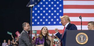 Donald Trump with Eugene Sims and Andreas Hestler on stage at a rally