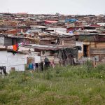 Informal settlement of corrugated metal shacks with laundry hanging