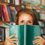 Jill Biden’s Bestseller Vanishes Overnight – Pulled From Shelves! Woman holding a green book in front of her face in a library