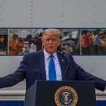 Trump Goes on Bizarre TANGENT at G7 Summit Donald Trump speaks at a podium with arms outstretched