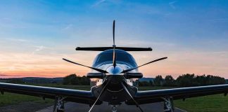 Single-engine propeller airplane on runway at sunset