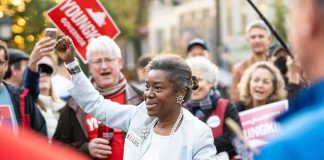 Freddie Williams II at a public rally with supporters in the background
