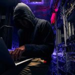Trump Demands ALL 50 States – Clean Up Or ELSE! Hooded person using a laptop in a dark server room