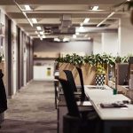 Bank SHUTS DOWN All Trump’s Accounts! Open-plan office with empty desks and plants along partitions