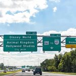 Overhead highway signs for theme park exits