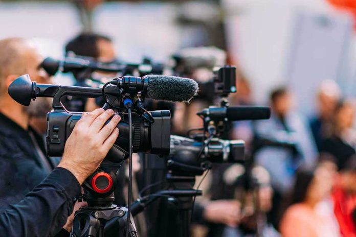 shutterstock_2233193507-5 Video cameras on tripods at a media event