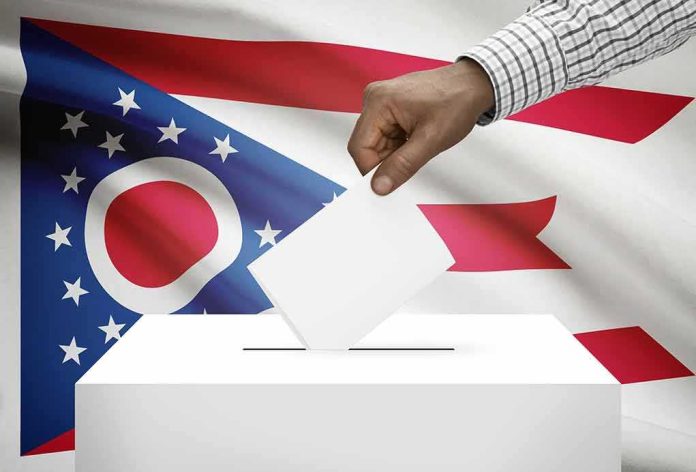 Hand casting ballot against Ohio flag backdrop
