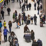Crowd of travelers in an airport arrivals hall