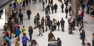 Crowd of travelers in an airport arrivals hall