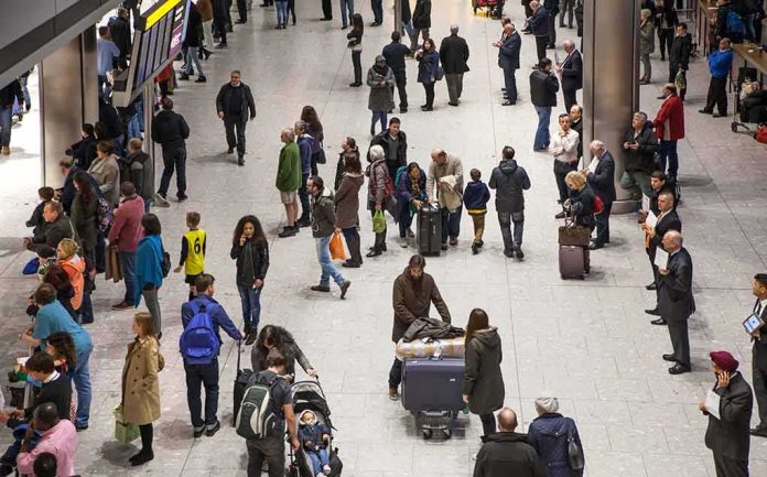 Crowd of travelers in an airport arrivals hall
