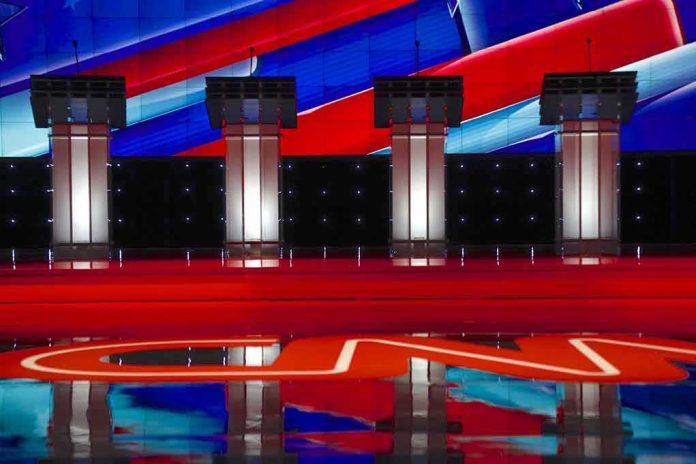 Debate stage with four empty podiums and bright red and blue backdrop