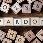 Disgraced Star Begs Trump For Pardon Wooden letter blocks arranged to spell 'PARDON' on a wooden surface