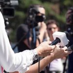 Reporters Reaction Goes VIRAL After Cockroach Invasion Reporters hold microphones during an outdoor press interview