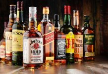 Assorted whiskey bottles arranged on a wooden surface