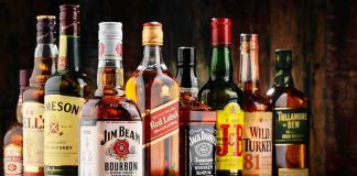 Assorted whiskey bottles arranged on a wooden surface