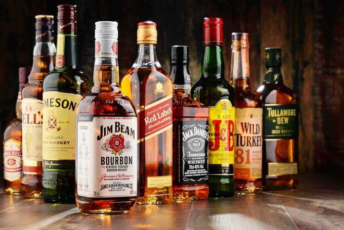 shutterstock_538308844 Assorted whiskey bottles arranged on a wooden surface