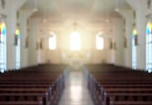Empty church interior with sunlight at the altar