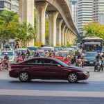 Urban traffic at intersection with motorbikes and car