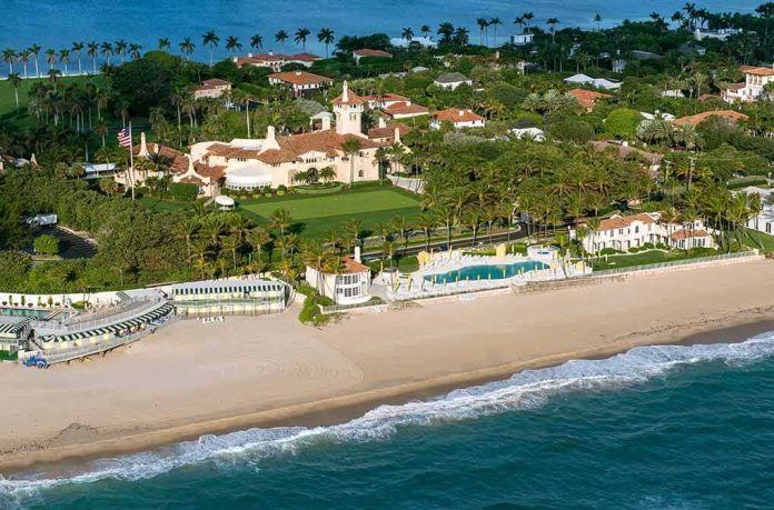 Aerial view of a beachfront estate with pool and palm trees
