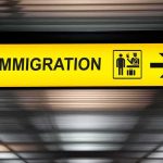 Immigration sign with arrow in airport
