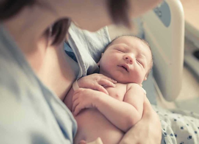 newborn baby sleeping in a parent's arms