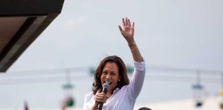 Kamala Hits Five States – 2028 Push Begins Kamala Harris waves while speaking to a crowd with a microphone