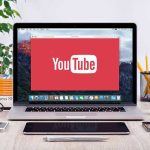 Deepfake Ads Are Flooding Campaigns – Here’s How to Spot Them YouTube logo on a laptop screen on desk.