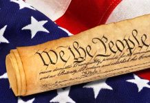 Rolled U.S. Constitution on an American flag
