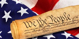 Body Armor Ban Ruled Unconstitutional in Major 2A Win Rolled U.S. Constitution on an American flag