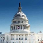 United States Capitol building with dome under clear blue sky