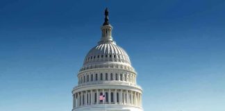 United States Capitol building with dome under clear blue sky