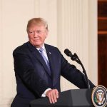 Trump Doubles Down $5,000 – Says When They’re Coming man at podium with presidential seal