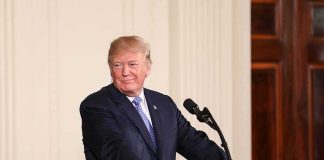 Trump Doubles Down $5,000 – Says When They’re Coming man at podium with presidential seal