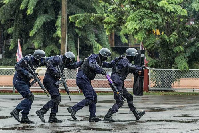 Police tactical team advancing in rain